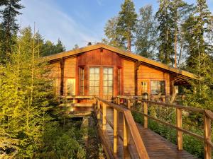 a log cabin in the woods on a wooden bridge at Saarilandia in Savonlinna