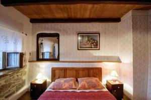 a bedroom with a bed and a mirror and two lamps at The Grandview Residence in Buzet +22 photos