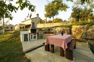 a table with a candle on it in front of a house at The Grandview Residence in Buzet