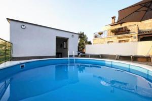 a large blue swimming pool in front of a building at The Grandview Residence in Buzet