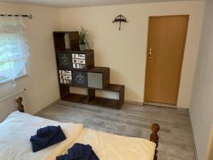 a bedroom with a bed and a room with a door at Ferienwohnung Mutzelmann in Kurort Gohrisch