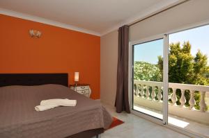 a bedroom with a bed and a large window at Beachhouselagos in Lagos