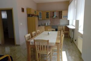 a kitchen with a table and chairs in a room at Apartmán U parku ve Strážnici - Jižní Morava in Strážnice