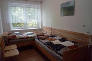 a bedroom with two beds and a window at Apartmán U parku ve Strážnici - Jižní Morava in Strážnice