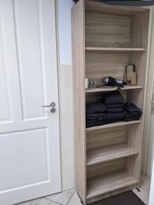 a closet with wooden shelves and a door at Logies21 Texel in Oosterend