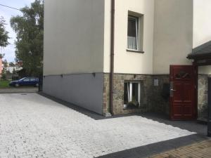 a building with a red door on the side of it at Green Apartment House in Bielsko-Biała