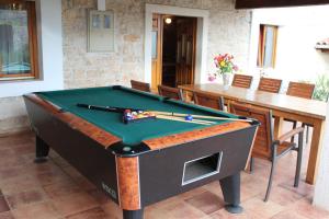 a pool table in a room with a table at Villa Barbara - Orihi in Barban