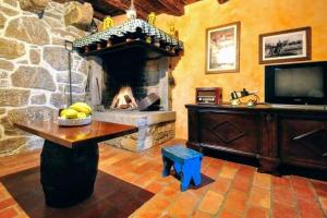 a living room with a stone fireplace and a television at The Grandview Residence in Buzet