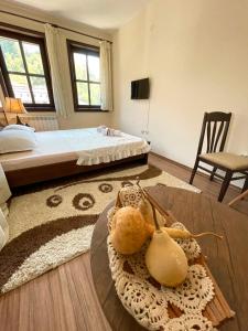 a room with a bed and a table with a animal on it at Hotel Slavova Krepost in Melnik