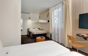 Ένα ή περισσότερα κρεβάτια σε δωμάτιο στο Kyriad Clermont-Ferrand-Sud - La Pardieu