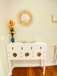 a white dresser with a mirror on the wall at BILBAO AEROPUERTO in Derio