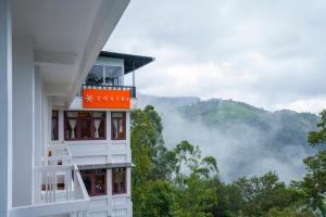a building with a view of the mountains at Zostel Munnar in Munnar