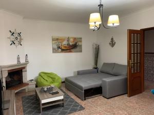een woonkamer met een bank en een tafel bij West coast dream Nazare in Nazaré