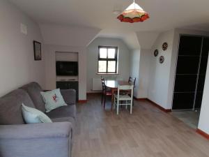 a living room with a couch and a table at Self catering upstairs apartment at Tradcottage in Sligo