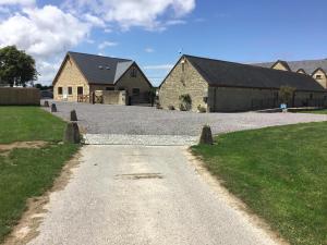 a driveway leading to a house with a building at Whaddon Grove House in Melksham