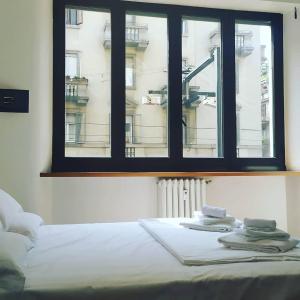 Ένα ή περισσότερα κρεβάτια σε δωμάτιο στο B&B APARTAMENTS Milano Bocconi