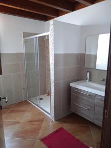 a bathroom with a shower and a sink at CASA RURALE IMPASTATO in Montevago