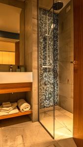 a shower in a bathroom with a glass shower backdoor at GoConcept Studio Sardegna in Olbia