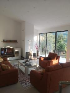 a living room with two couches and a table at Villa Alfareed فيلا الفريد سراييفو in Sarajevo