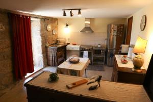 a kitchen with a counter and a table in a room at Casa das Lages in Viariz +69 photos