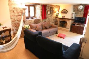 a living room with a couch and a fireplace at Casa das Lages in Viariz