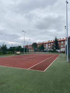 an empty tennis court in front of a building at Coto Carcedo in Salinas