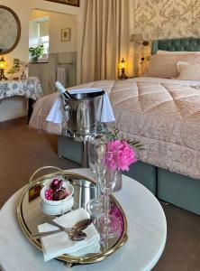 a table with a tray of food on top of a bed at Bedford House & Hall in Balbriggan