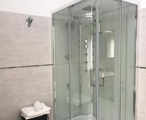 a shower with a glass door in a bathroom at Dimora Del Riccio in Bergamo