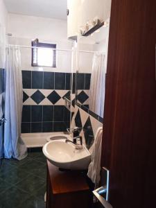 a bathroom with a sink and a bath tub at Guesthouse Alliya in Dubrovnik