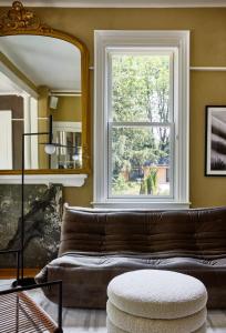 a living room with a couch and a window at AWOL Kennebunkport in Kennebunkport
