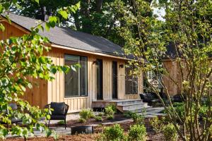 a log cabin with a porch and chairs in a yard at AWOL Kennebunkport in Kennebunkport