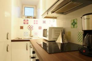 a kitchen with a microwave and a counter top at Costa do Castelo Terrace in Lisbon
