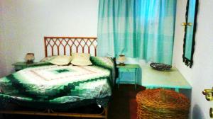 ポルト・チェルボにあるBeautiful Villa With Sea View to Porto Cervoのベッドルーム1室(ベッド1台、テーブル、椅子付)