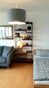 a living room with a couch and a lamp at Apartment Weitblick in Schweinfurt