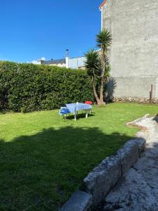 een picknicktafel in het gras in een tuin bij Casa El Hórreo in Laxe