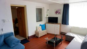 a living room with a couch and a tv at P7-Nyaraló in Magyarhertelend