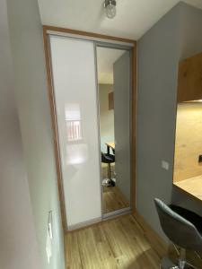 a sliding glass door in a room with a desk at Apartament Artemida Kletno in Stronie Śląskie