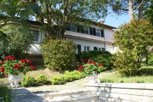 a house with red flowers in front of it at Villa La Paleotta in Fano +1 photo