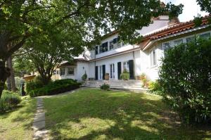 a large white house with a yard and stairs at Villa La Paleotta in Fano