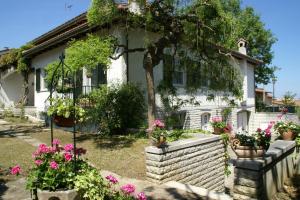 a white house with flowers in front of it at Villa La Paleotta in Fano
