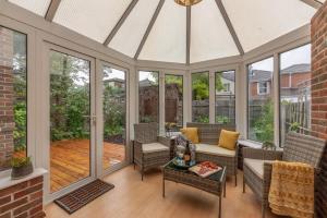 a screened in porch with a white ceiling at Luxury Southampton house with garden and parking in Southampton