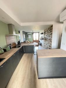 a large kitchen with wooden floors and a counter top at L’alsace in Carcassonne