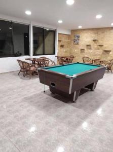 a pool table in a room with tables and chairs at Butterfly Studios, Faliraki in Faliraki