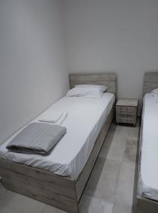 a bedroom with a large bed and two night stands at Ladenis Studios in Nea Plagia +8 photos