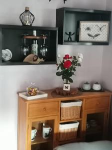 a room with a wooden desk with a vase of flowers at Casa Fagundo in Puntagorda