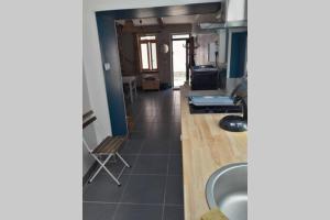 a view of a kitchen with a sink at Maison de pêcheur près du port in Étaples
