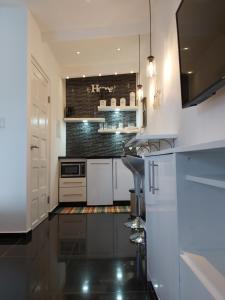 a kitchen with white appliances and a black floor at KDF Apartments in Willemstad