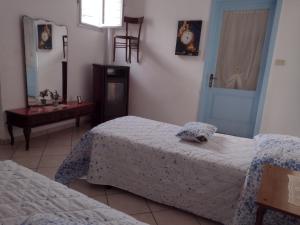 Ένα ή περισσότερα κρεβάτια σε δωμάτιο στο Villetta Maria: casa-vacanze nel cuore del Salento