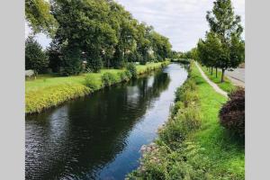 a river with trees on the side of it at Le Studio 11 Abbeville centre baie de Somme in Abbeville