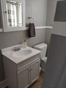 La salle de bains blanche est pourvue d'un lavabo et de toilettes. dans l'établissement The Lewis House-Upper Level-A Peaceful Spot!, à Laramie